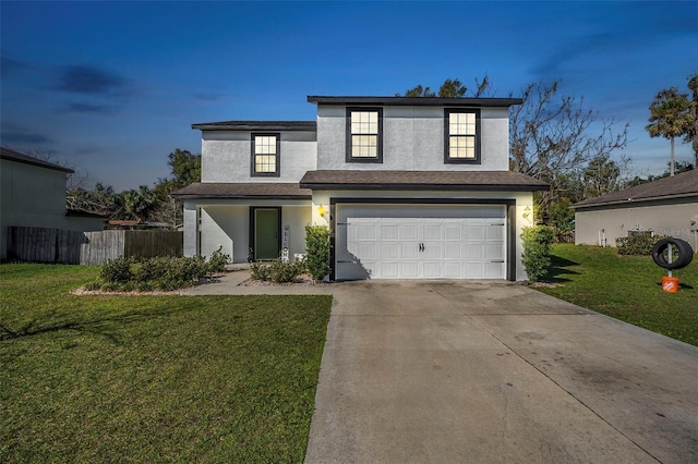 front facade featuring a garage and a lawn