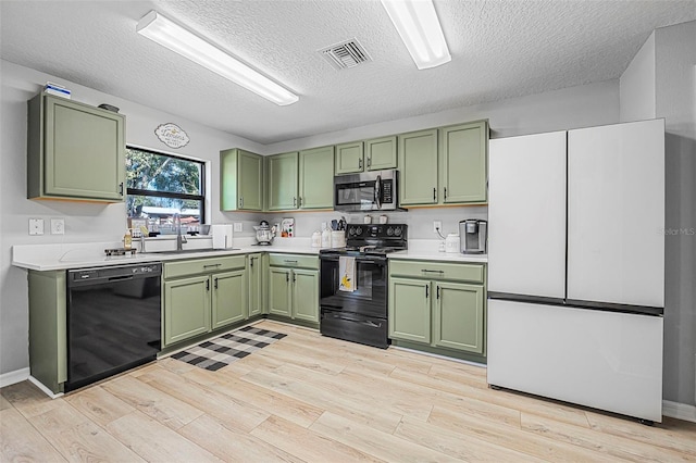 kitchen featuring sink, green cabinets, and black appliances