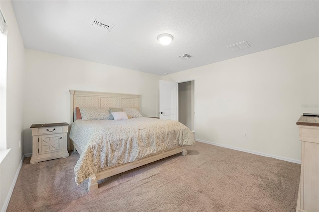 carpeted bedroom with a textured ceiling