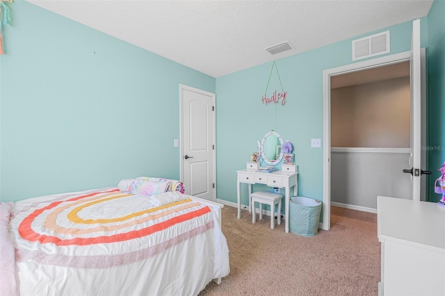 bedroom featuring carpet floors and a textured ceiling