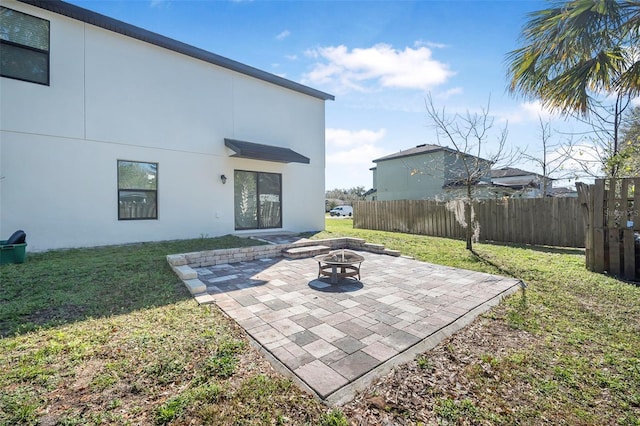 exterior space with a patio, a fire pit, and a lawn