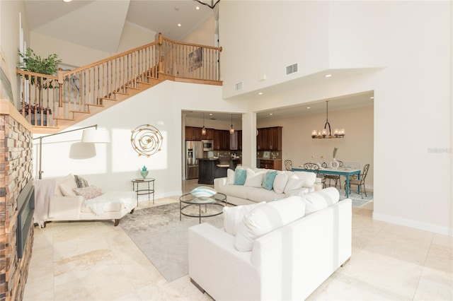 living room featuring a chandelier and a high ceiling