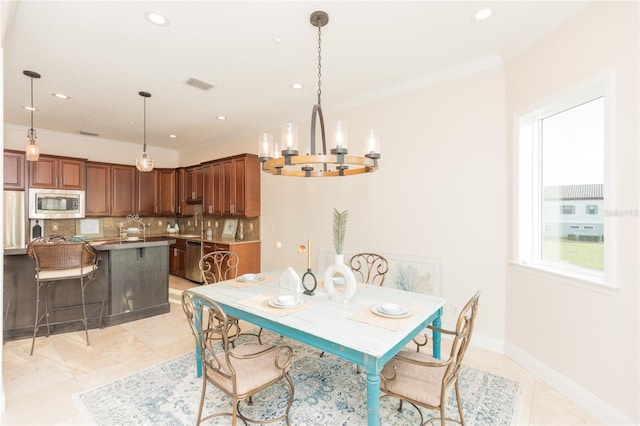 dining space with crown molding, light tile patterned floors, and an inviting chandelier