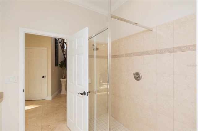 bathroom with tile patterned flooring, crown molding, and walk in shower