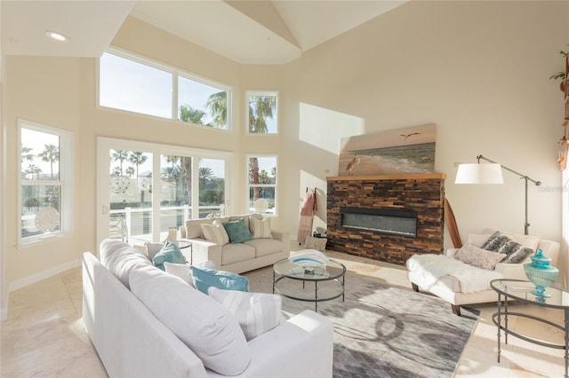 220 Harbor Village Pt N, Palm Coast, FL 32137 - living area featuring tile patterned flooring, high vaulted ceiling, baseboards, and a fireplace