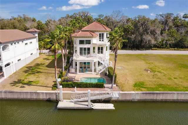 220 Harbor Village Pt N, Palm Coast, FL 32137 - rear view of house featuring a balcony, a water view, a patio, stairway, and a yard