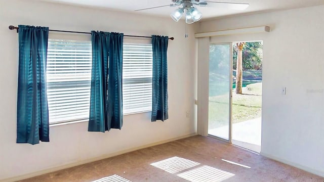 spare room with ceiling fan and carpet flooring