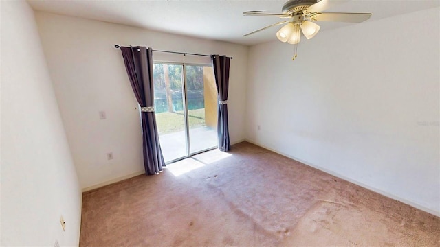 empty room featuring carpet floors and ceiling fan