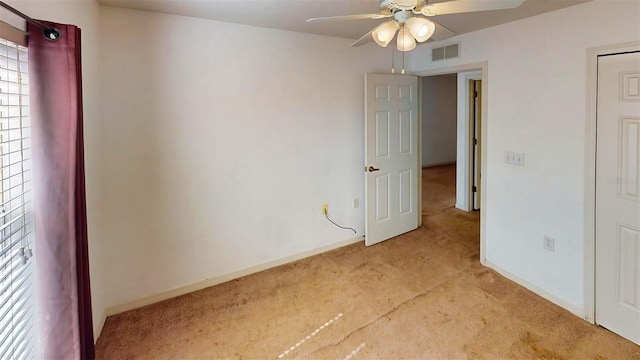 carpeted empty room with ceiling fan