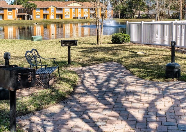 view of community with a water view and a yard