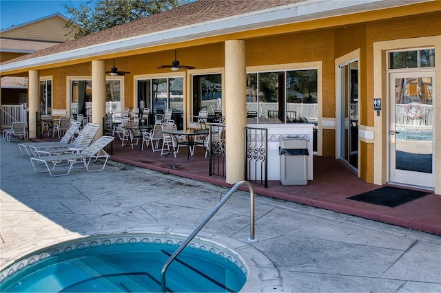 exterior space featuring a community hot tub and ceiling fan