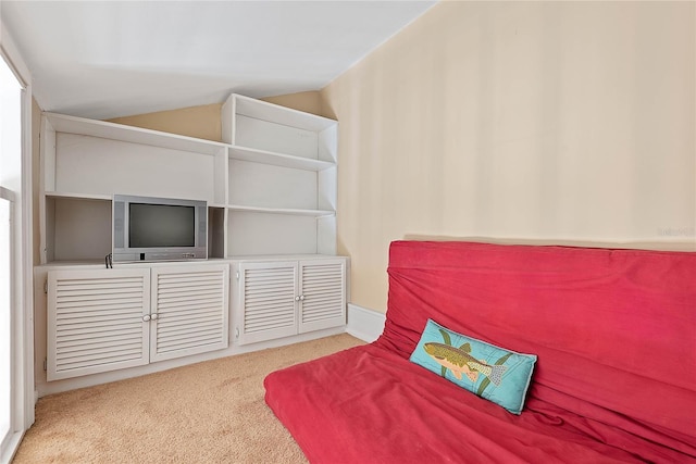 bedroom with light carpet and vaulted ceiling