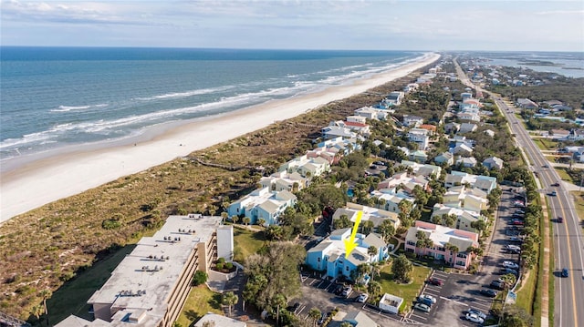 birds eye view of property featuring a water view, a residential view, and a view of the beach