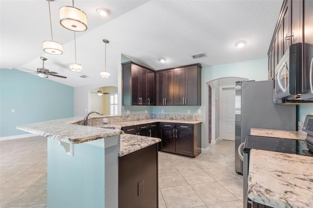 kitchen with kitchen peninsula, stainless steel appliances, decorative light fixtures, dark brown cabinets, and light stone counters