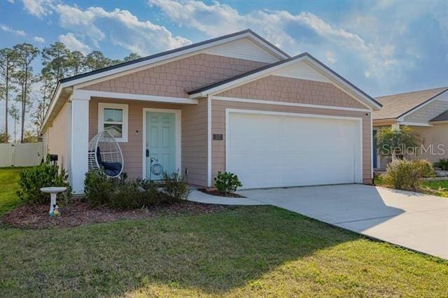 view of front of home with a garage and a front lawn