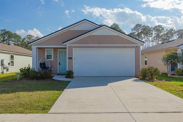 view of front facade with a garage and a front lawn