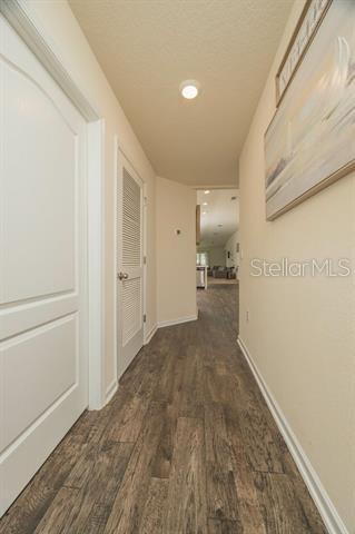 hall with dark hardwood / wood-style floors