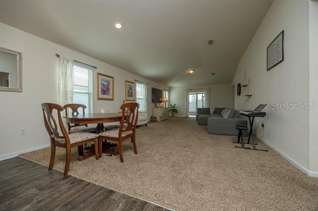 dining area featuring plenty of natural light, hardwood / wood-style floors, and lofted ceiling