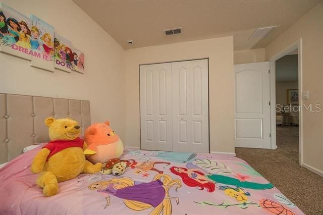 carpeted bedroom featuring a closet