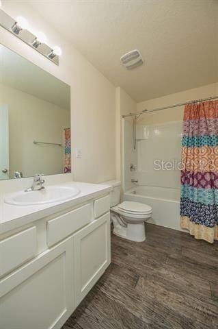 full bathroom featuring shower / bathtub combination with curtain, hardwood / wood-style floors, vanity, and toilet