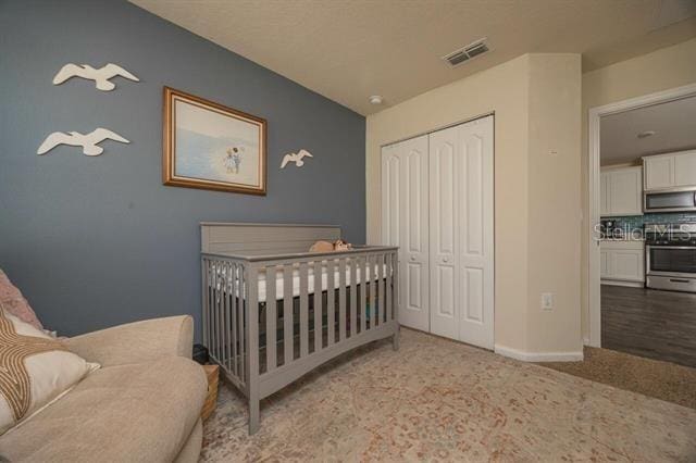 carpeted bedroom with a closet