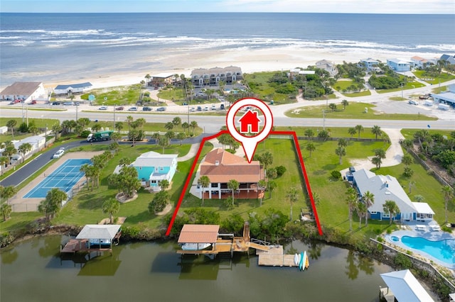 bird's eye view featuring a water view and a beach view