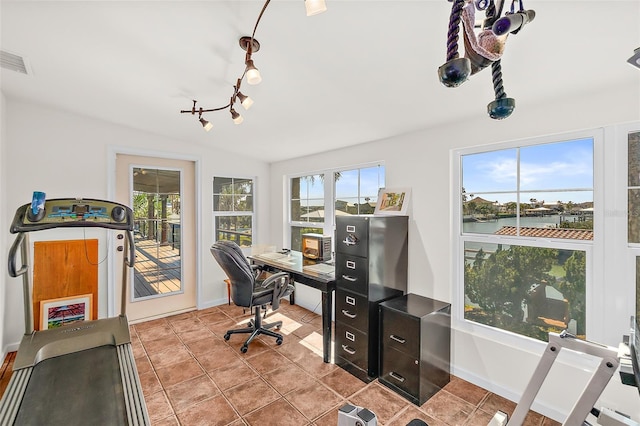 tiled office featuring a water view and rail lighting