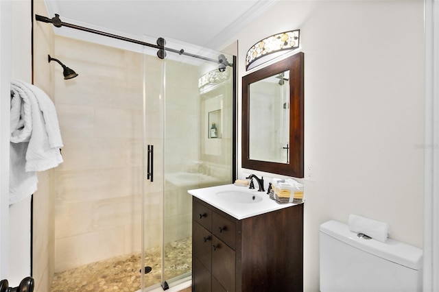 bathroom with vanity, ornamental molding, toilet, and walk in shower