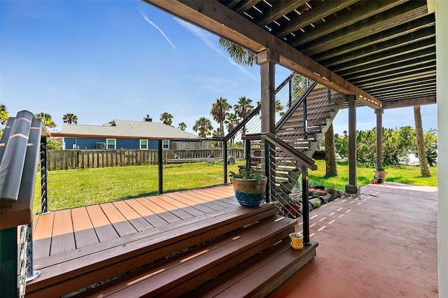 wooden deck featuring a patio and a lawn