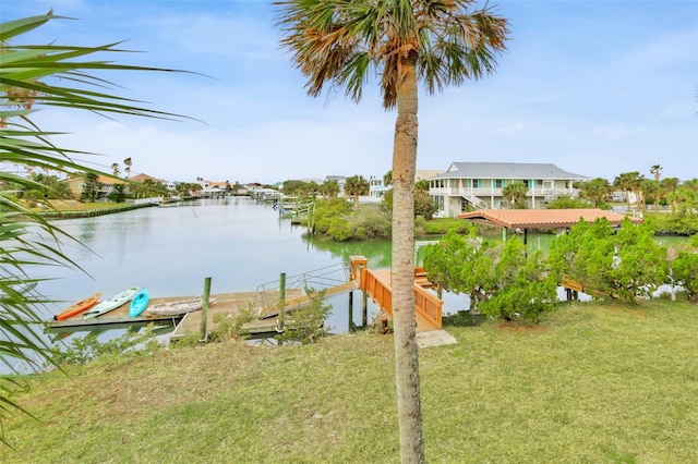 view of yard featuring a boat dock and a water view