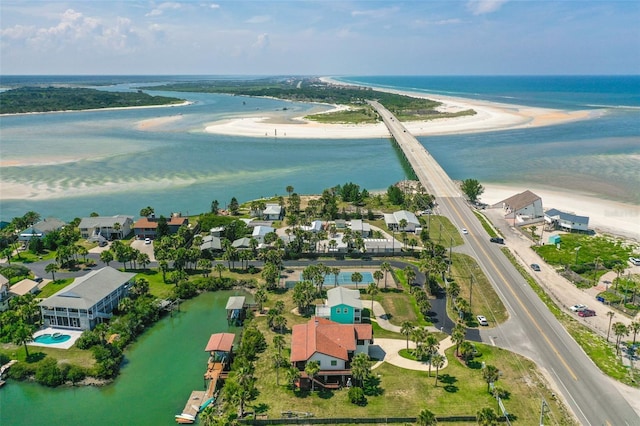 drone / aerial view featuring a water view and a view of the beach