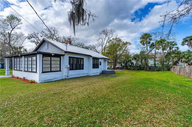 back of house featuring a lawn