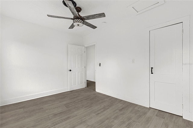 unfurnished bedroom with dark hardwood / wood-style flooring and ceiling fan