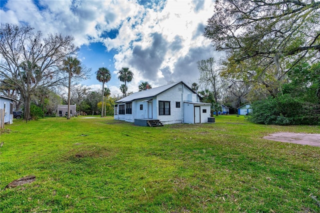 back of house featuring a lawn