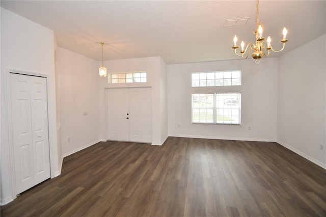 foyer entrance with a chandelier, dark wood-style flooring, visible vents, and baseboards