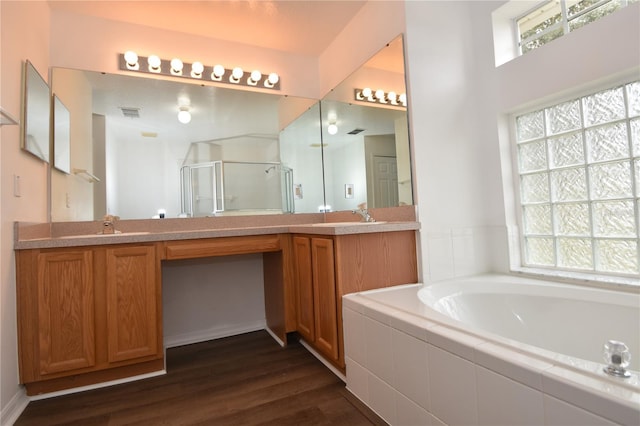 bathroom featuring a garden tub, visible vents, a stall shower, vanity, and wood finished floors