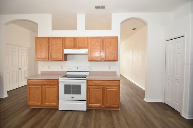 kitchen with arched walkways, visible vents, light countertops, electric range, and under cabinet range hood