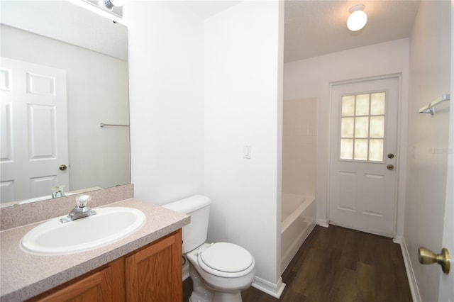 full bathroom with vanity, toilet, and wood finished floors