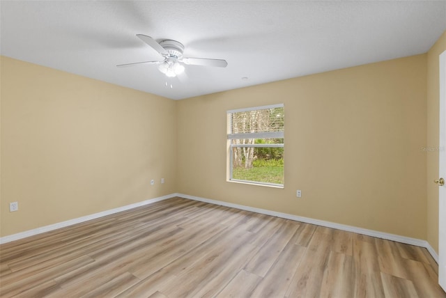 spare room featuring light hardwood / wood-style floors and ceiling fan