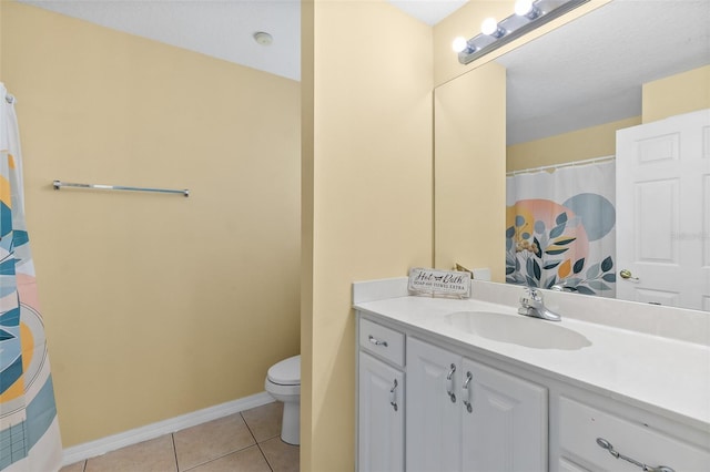 bathroom featuring vanity, tile patterned floors, and toilet