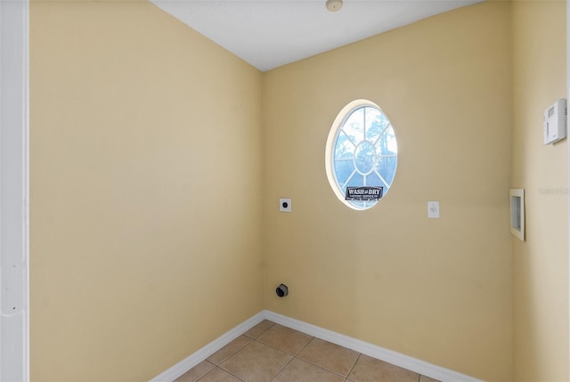 laundry area featuring hookup for a washing machine, hookup for an electric dryer, and light tile patterned floors