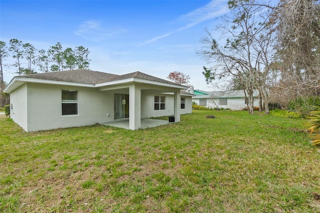 rear view of property with a patio area and a lawn