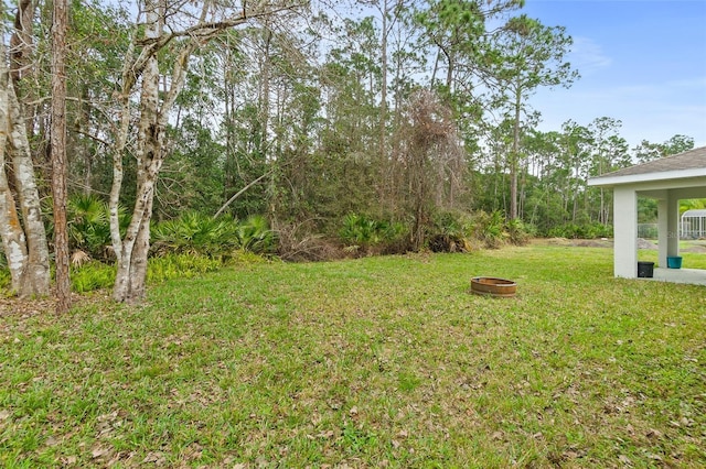 view of yard with a fire pit