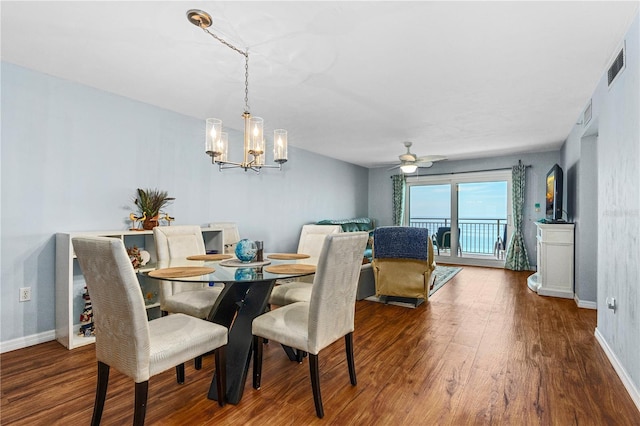 dining room featuring hardwood / wood-style flooring and ceiling fan with notable chandelier