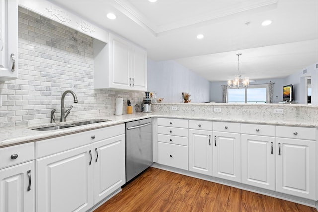 kitchen featuring decorative light fixtures, dishwasher, sink, and white cabinets