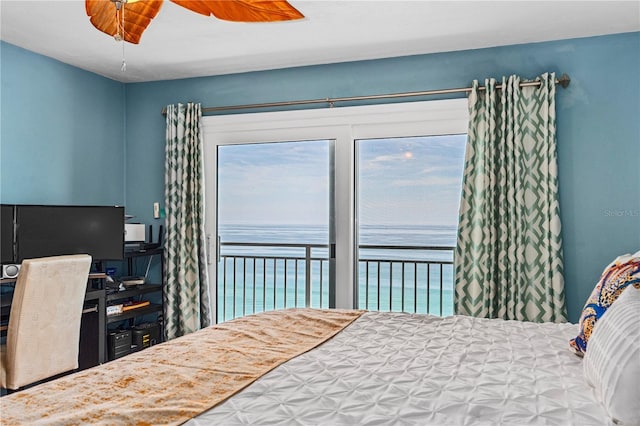 bedroom featuring ceiling fan and a water view