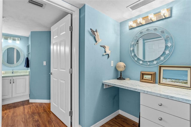 bathroom featuring hardwood / wood-style flooring and vanity