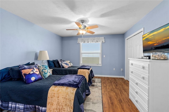 bedroom with wood-type flooring and ceiling fan