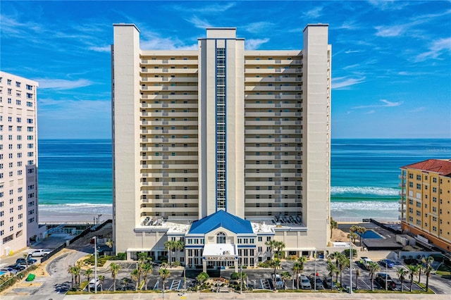 view of property with a beach view and a water view