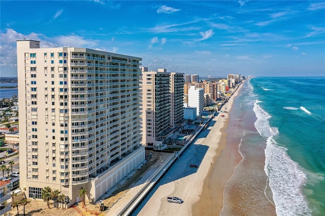 bird's eye view featuring a water view and a beach view